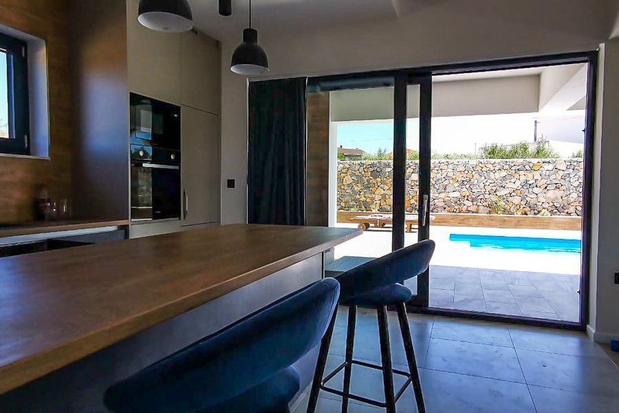 Cuisine avec vue sur la terrasse et la piscine