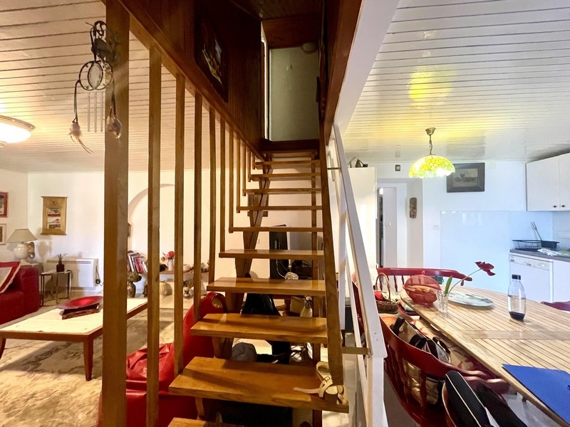 Séjour ouvert avec escalier et cuisine