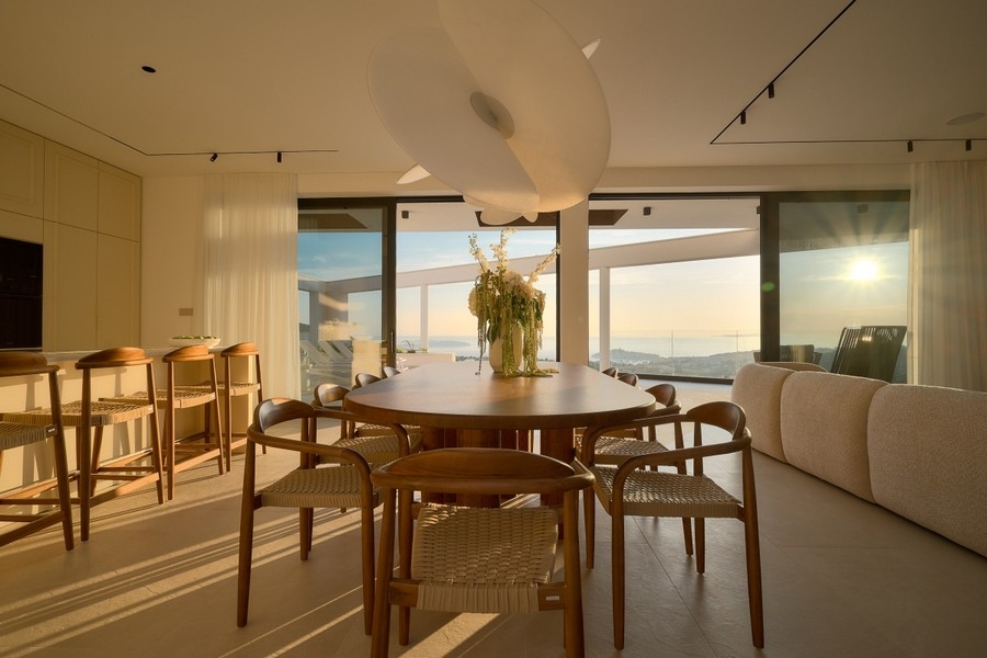 Coin repas avec fenêtres panoramiques et vue mer