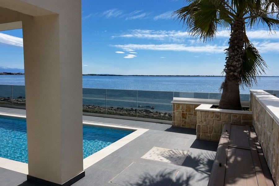 Espace piscine avec palmier et vue mer