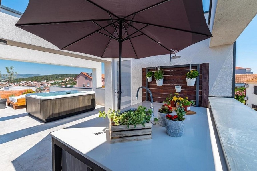 Espace extérieur couvert avec jacuzzi et vue mer