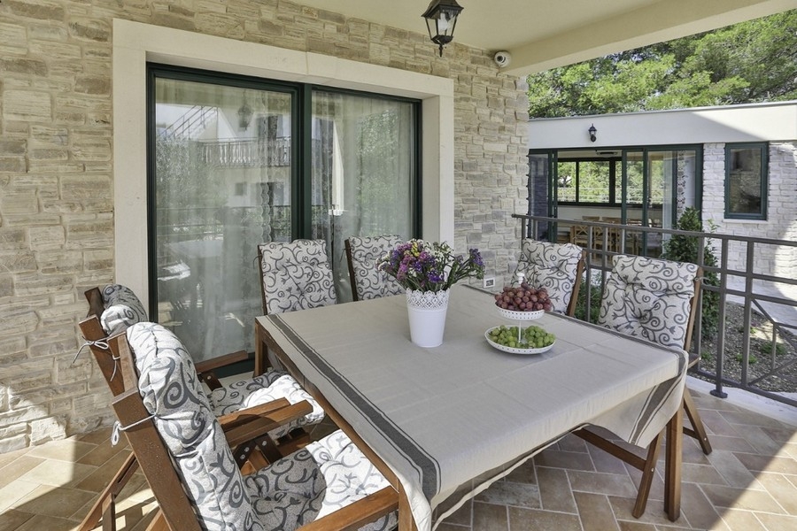 Terrasse couverte avec coin salon et table