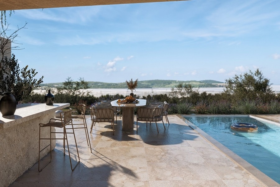 Terrasse avec coin salon au bord de la piscine avec vue mer