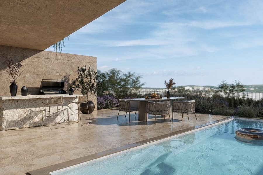 Cuisine extérieure avec comptoir de bar à côté de la piscine