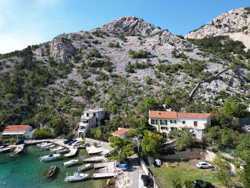 Baie à l'eau limpide et montagnes du Velebit vues d'en haut