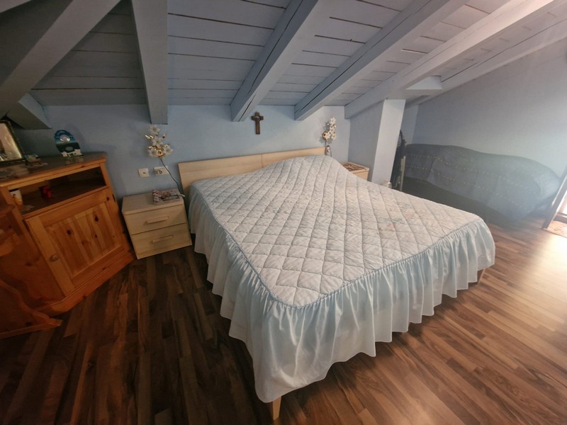 Chambre avec lit double et parquet