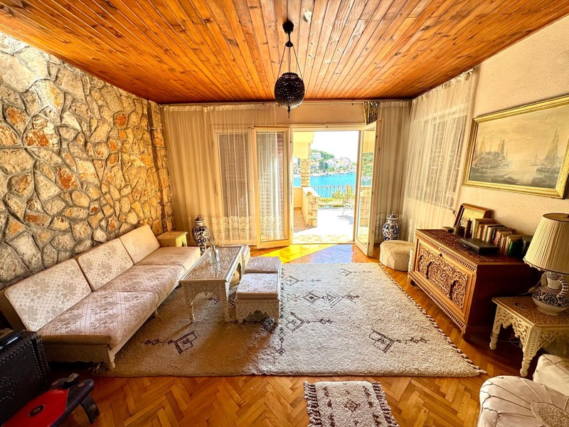 Salon avec plafond en bois et accès à la terrasse
