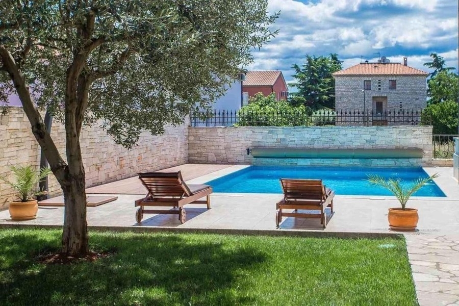 Piscine chauffée avec bains de soleil dans le jardin