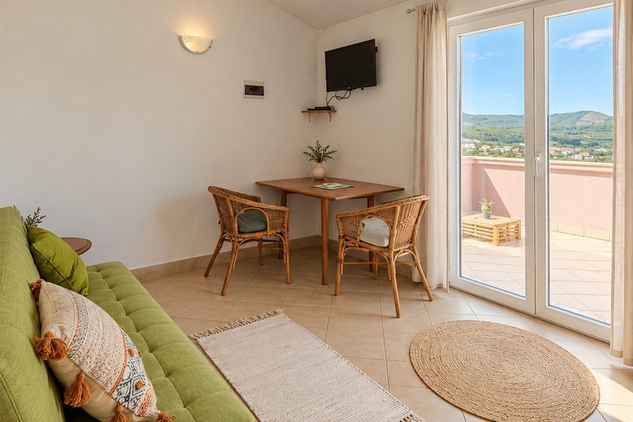 Salon d'un appartement avec canapé et porte donnant sur la terrasse