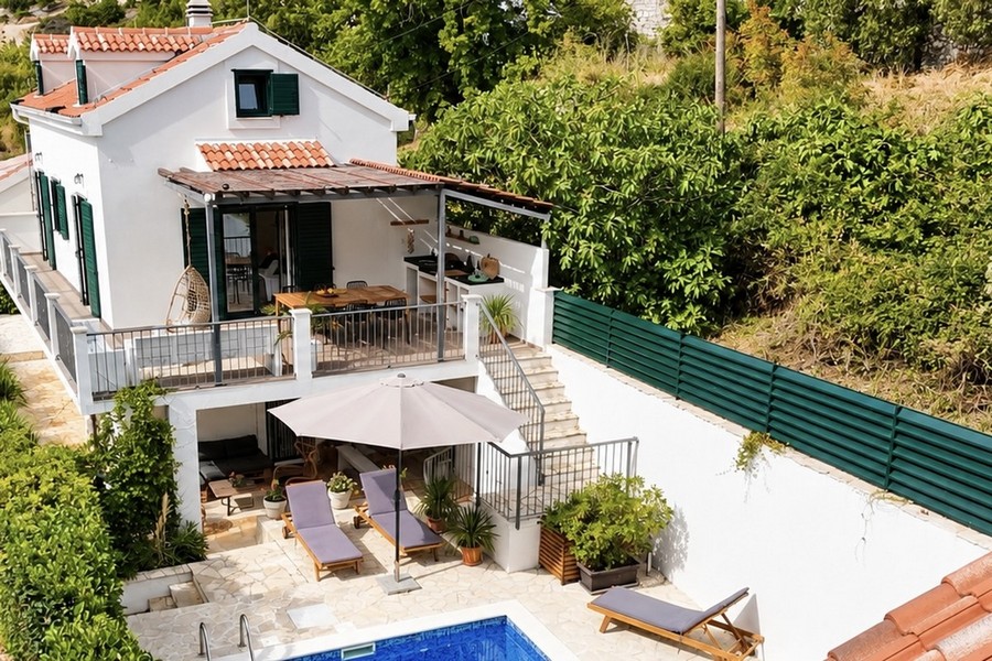 Vue d'en haut sur la terrasse, la piscine et le jardin