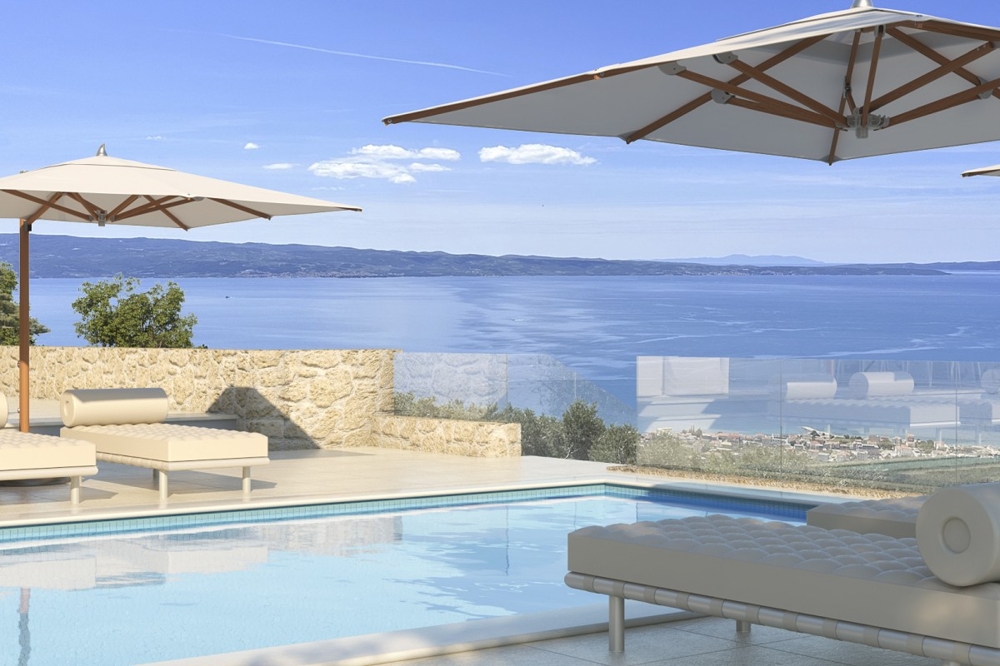 Piscine avec espace détente et vaste vue mer