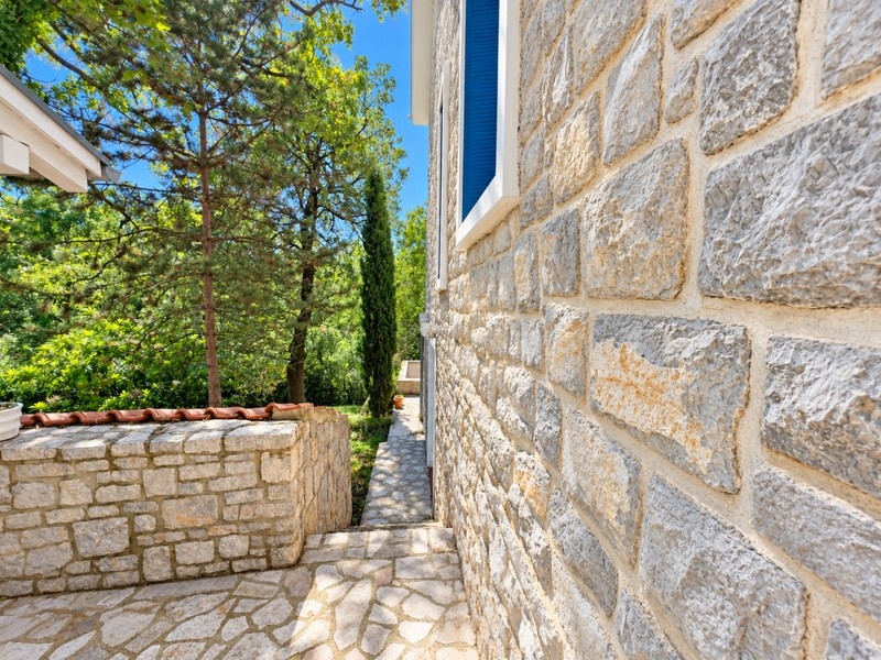 Façade en pierre et chemin le long de la maison
