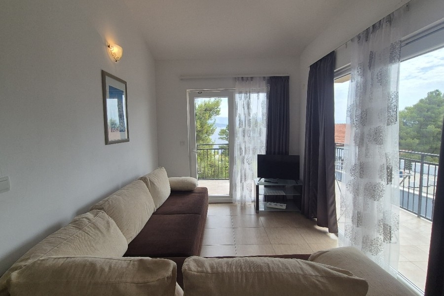 Salon avec canapé et porte donnant sur la terrasse