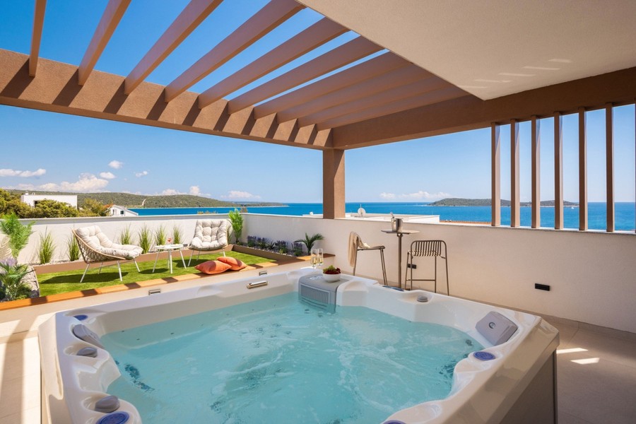 Jacuzzi sous la pergola avec vue mer