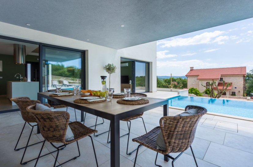 Terrasse couverte et piscine à l'extérieur.